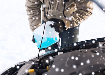 Image showing closeup of man pouring antifreeze into car