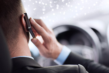 Image showing close up of man using smartphone while driving car