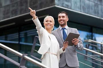 Image showing smiling businessmen with tablet pc outdoors