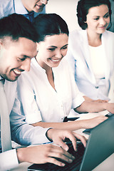 Image showing group of people working with laptops in office