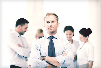 Image showing handsome businessman with team in office