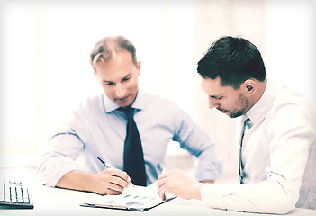 Image showing businessmen with notebook on meeting