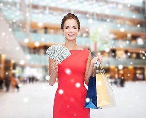 Image showing smiling elegant woman in dress with shopping bags