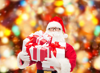 Image showing man in costume of santa claus with gift boxes