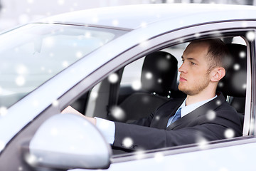 Image showing close up of businessman driving car