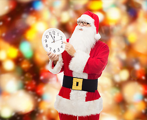 Image showing man in costume of santa claus with clock