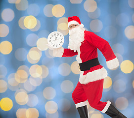 Image showing man in costume of santa claus with clock