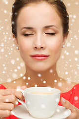 Image showing smiling woman in red dress with cup of coffee