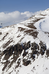 Image showing Off-piste slope with stones and chair-lift in little snow year