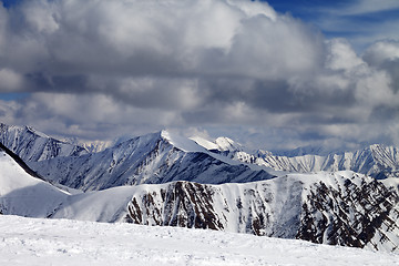 Image showing Winter snowy mountains in clouds