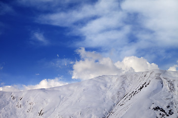 Image showing Off-piste slope at evening and sky with clouds