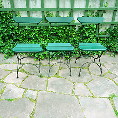 Image showing Green chairs in summer garden