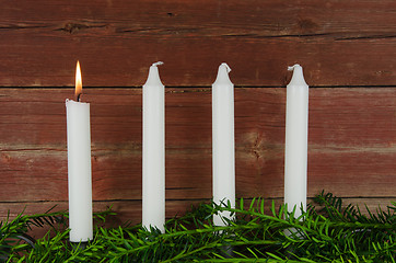 Image showing Four advent candles at an old plank wall