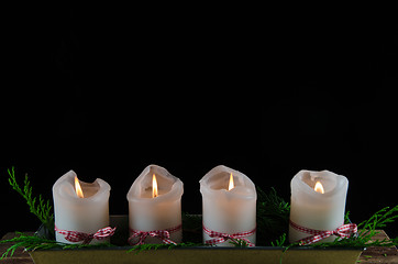Image showing Four decorated advent candles at black background