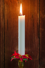 Image showing Single burning candle with decorated candle-ring