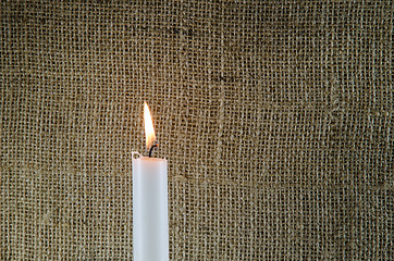 Image showing Burning candle with burlap background