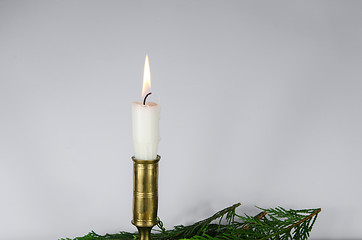 Image showing One white candle at a white background