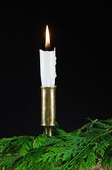 Image showing One candle with green twigs