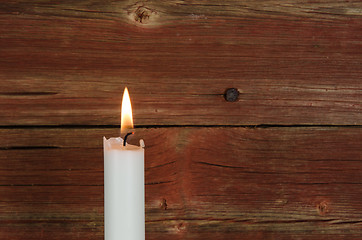 Image showing Single candlelight at old wall