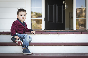 Image showing Melancholy Mixed Race Boy Sitting on Front Porch Steps