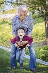 Image showing Chinese Grandpa Having Fun with His Mixed Race Grandson Outside