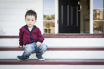 Image showing Melancholy Mixed Race Boy Sitting on Front Porch Steps