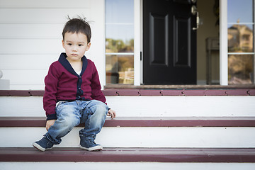 Image showing Melancholy Mixed Race Boy Sitting on Front Porch Steps