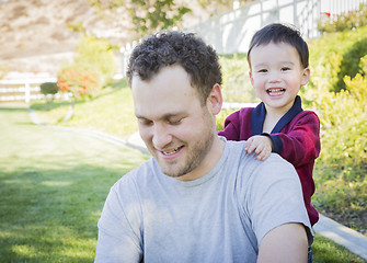 Image showing Caucasian Father Having Fun with His Mixed Race Baby Son