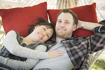 Image showing Mixed Race Couple Relaxing in a Hammock