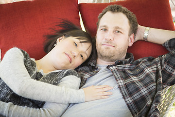 Image showing Mixed Race Couple Relaxing in a Hammock