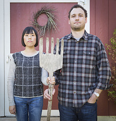 Image showing Fun Mixed Race Couple Portrait Simulating the American Gothic Pa