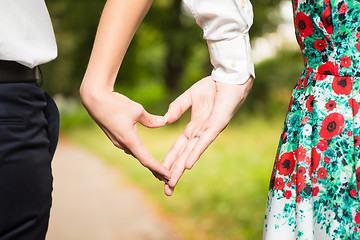 Image showing Bride and groom standing together with heart