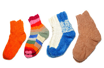 Image showing Warm knitted woolen socks knitting needles isolated on a white background