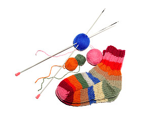 Image showing Warm knitted woolen socks knitting needles isolated on a white b