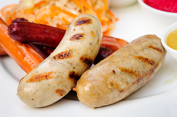 Image showing German sausage with cabbage and sauces