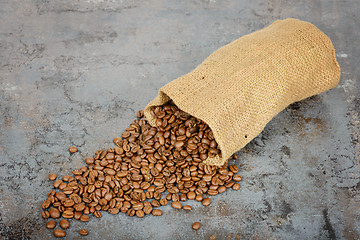 Image showing Coffee beans spilled out of the sack