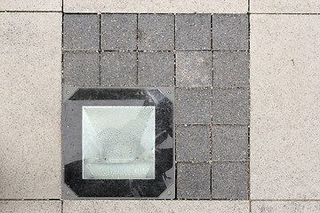 Image showing light source on stone pavement