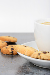 Image showing Half cup of coffee with cookies on the table