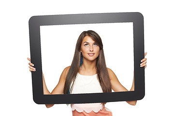 Image showing Woman looking to side through tablet frame