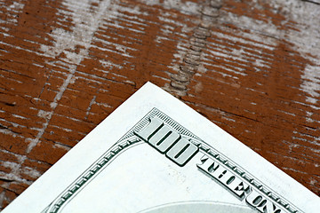 Image showing Hundreds of US dollars on old wooden plank