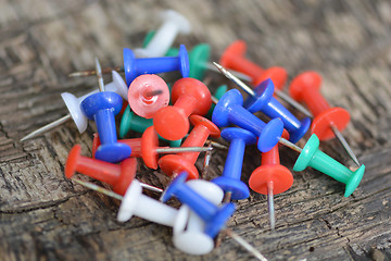 Image showing old push pins set on old wooden background