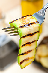 Image showing grilled zucchini courgette on a fork
