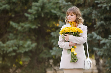Image showing Cute little girl with yellow roses awaiting appointment
