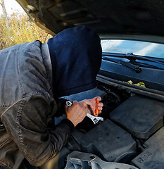 Image showing Hooligan breaking into car