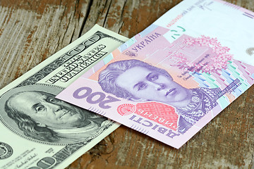 Image showing dollars euro hryvnia banknotes on wooden background