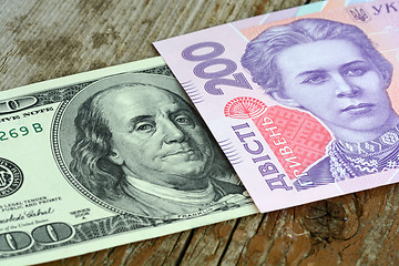 Image showing dollars euro hryvnia banknotes on wooden background