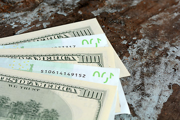 Image showing Hundreds of US dollars and euro on old wooden plank