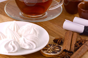 Image showing hot tea with lemon and cinnamon on wooden backgroubd