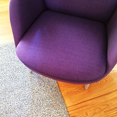 Image showing Fashionable purple armchair on wooden floor