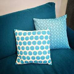 Image showing Stylish cushions decorating blue sofa